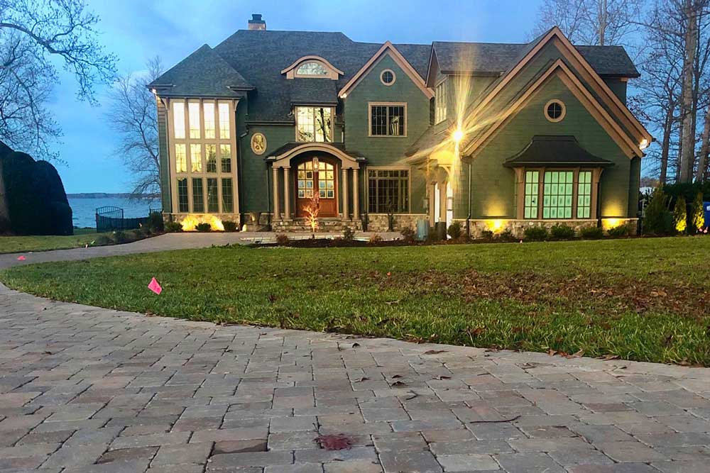 Front of Lake house with Paver Driveway and Landscape Lighting